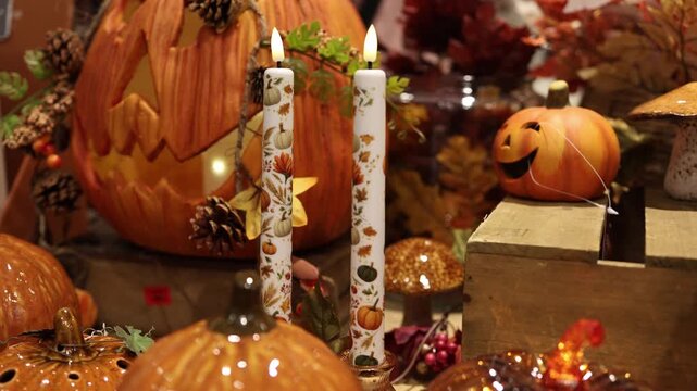 Autumn decor brings a cozy charm to a store display with smiling pumpkins patterned candles pinecones and warm earthy colors inviting shoppers to enjoy the beauty of fall