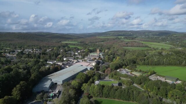 Buckfast, Devon, England: DRONE VIEWS: The village of Buckfast & Buckfast Abbey; in the background is Dartmoor National Park. The Abbey is run by Benedictine monks and produces its own wine.