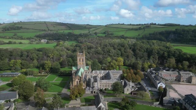 Buckfast, Devon, England: DRONE VIEWS: The village of Buckfast & Buckfast Abbey; in the background is Dartmoor National Park. The Abbey is run by Benedictine monks and produces its own wine.