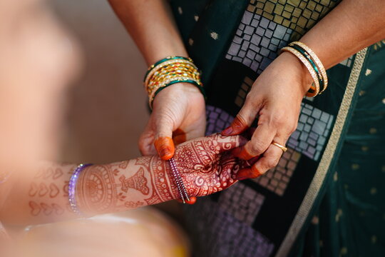 Traditional Indian bridal mehendi ceremony hands adorned with bangles