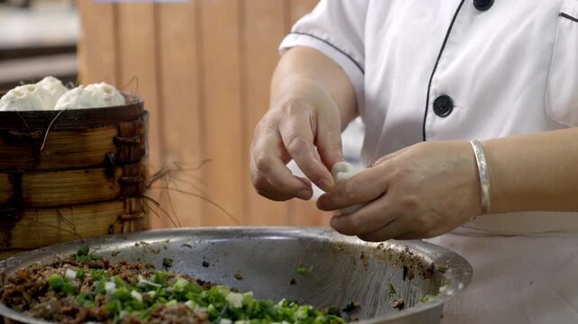 The chef is making meat buns
