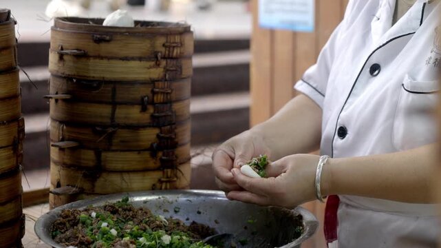 The chef is making meat buns