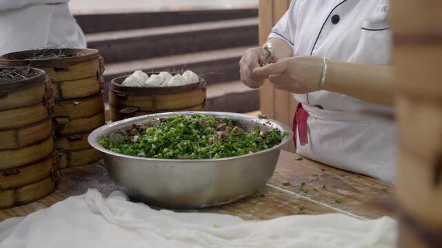 The chef is making meat buns