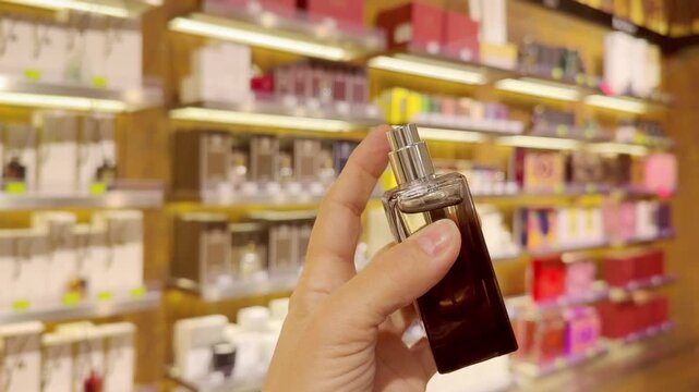 Perfume and Eau de Toilette Bottles on Display in Cosmetics Store &ndash; Fragrance Products on Shelf with Blurred Perfume Background