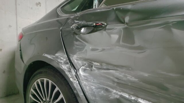 Severe Side Impact Car Damage with Deep Dents and Scratches on Rear Door