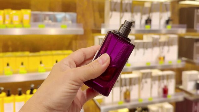 Perfume and Eau de Toilette Bottles on Display in Cosmetics Store &ndash; Fragrance Products on Shelf with Blurred Perfume Background