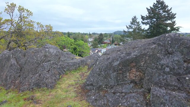 Langford, British Columbia, Canada - October 15, 2026: High angle overview of residential neighborhoods from a rocky hillside park