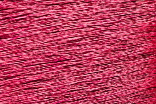 Magenta textured grass or fiber background with horizontal lines pattern