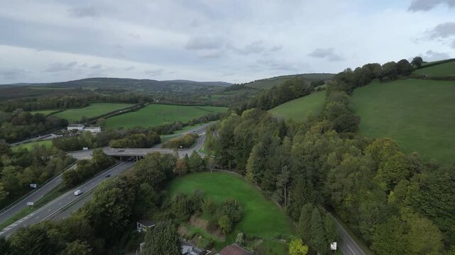 Buckfastleigh, Devon, England: DRONE VIEWS: 1. River Dart valley; 2. Devon Expressway (A38): Traffic; 3. A384 road: Traffic; 4. Dartmoor Park on the horizon. Devon is a popular UK tourist destination.