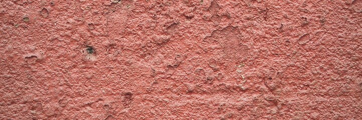 Rough red wall texture with peeling paint showing grunge and weathered surface © Harry
