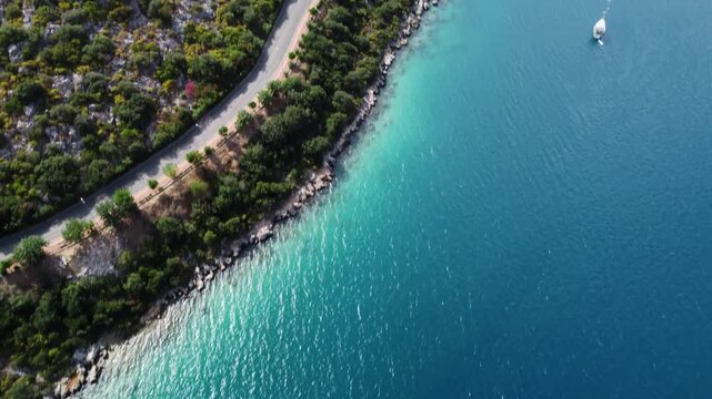 Winding coastal road between turquoise coves and pine islets with empty asphalt ribbon hugging cliffs. Panoramic sea vistas and remote driving energy perfect for road trip and exploration narratives