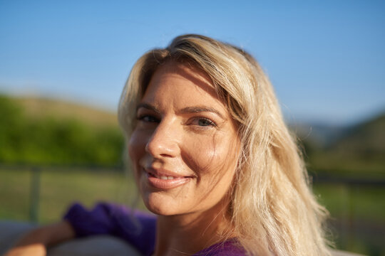 Smiling Blonde Woman Portrait Outdoors in Golden Light Relaxed Natural Expression Closeup
