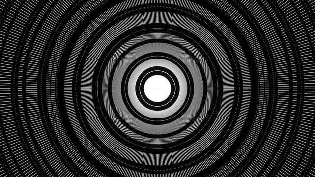 Black and white hypnotic concentric circles with radial line patterns creating an optical illusion.