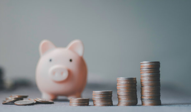 Piggy bank, stacked coins representing financial savings, investment growth, wealth accumulation, budgeting, retirement planning, economic stability, passive income, money management.