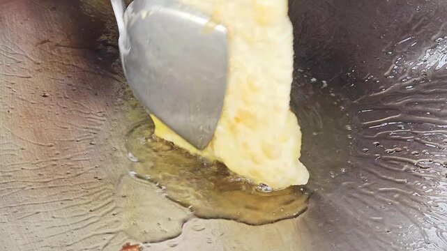 Fry the roti, fold it into a square shape, and flip it over to cook through.
