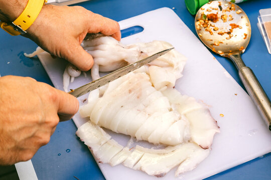 Preparing Fresh Fish on a Cutting Board in a Kitchen Setting
