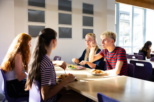 Four friends share a table in the canteen
