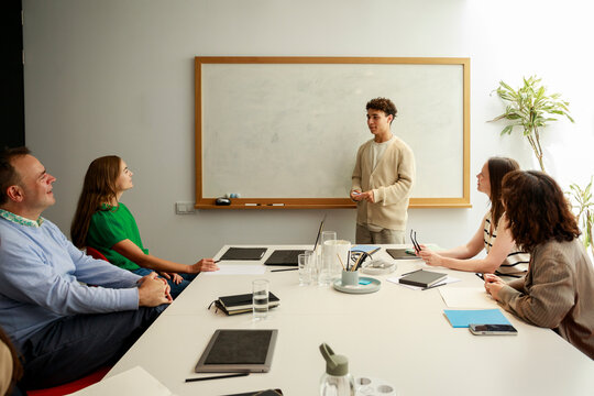 Teacher Explains Math Concepts to Students in a Classroom Setting