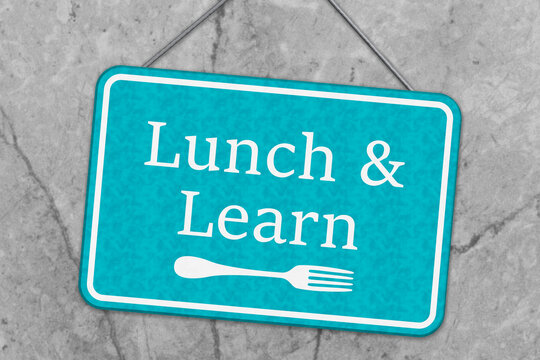 Blue Lunch and Learn sign on grey stone
