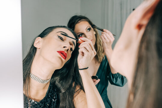 Two girls putting make up