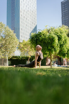 Woman Practicing Mindful Yoga Beneath the City Skyline