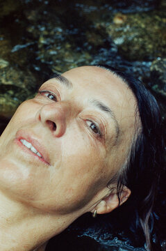Closeup portrait of a woman relaxing in a stream