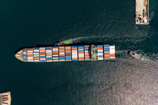 Container ship navigating through port waters