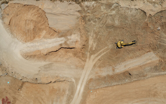 Excavator working on large construction site.