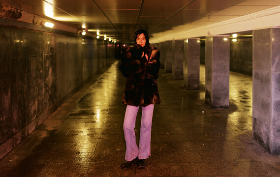 Person Standing in Underground Passage With Wet Floor