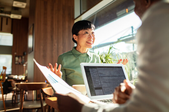 Smiling woman speaking during a business meeting in a cafe
