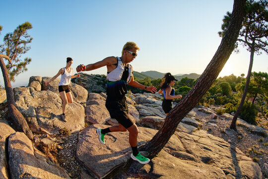 Running on rocky terrain during sunset near mountains