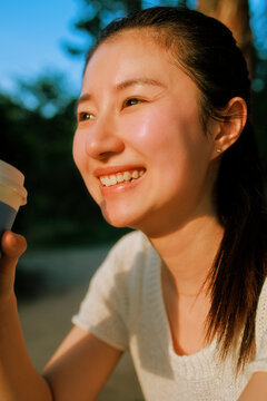 Joyful Woman Admiring the Sunset During the Golden Hour