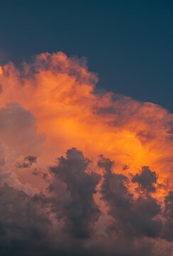 Dramatic orange sunset cloudscape against deep blue sky