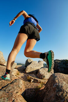 Runner navigating rocky terrain on a mountain