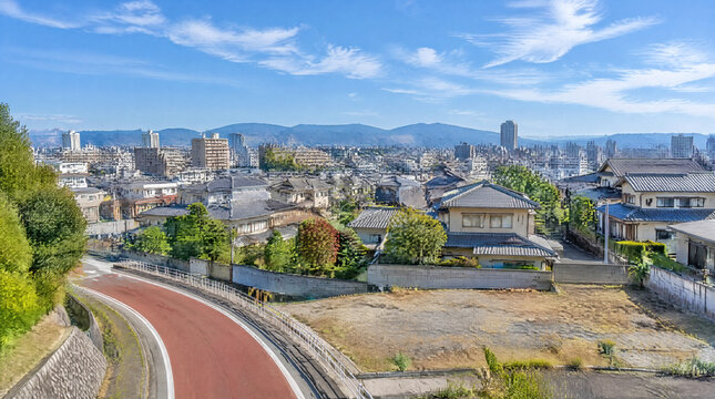 高台から見下ろす日本の住宅街と遠景の街並み