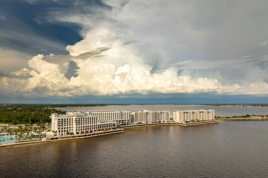 Tourists forced indoors at bay shore resort before hurricane storm. Interrupted vacation caused by extreme weather conditions.