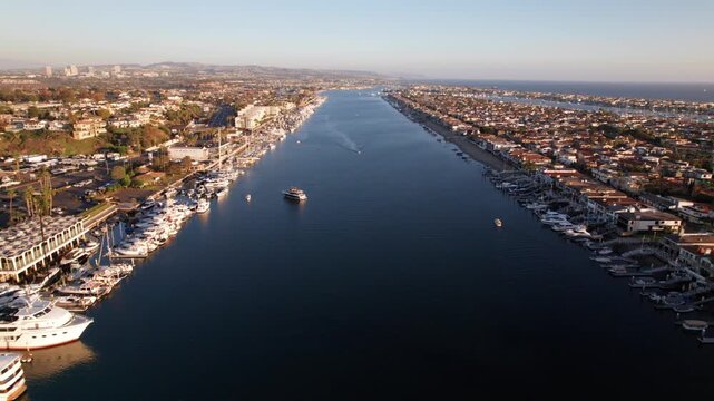 Newport Beach harbor channel lined with boats and waterfront homes