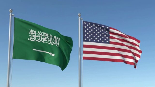 Saudi Arabian and United States flags waving together under blue sky cinematic motion