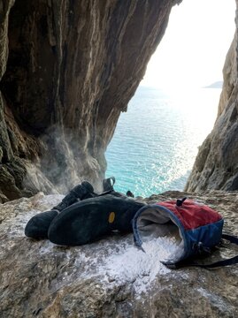 Professional Rock Climbing Shoes and Chalk Bag in Sea Cave