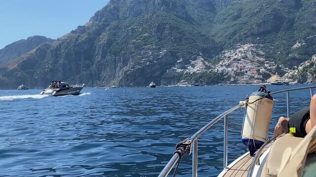 Boat fender tied with rope to the stainless rail for protection from scratches and impacts, speedboat riding along Amalfi coastline, unforgettable summer vacation