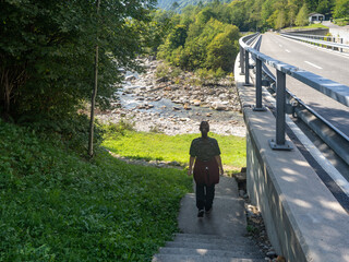 Hiker on Verzasca River trail (Sentiero Verzasca) from Sonogno to Lavertezzo, Switzerland © Catalin