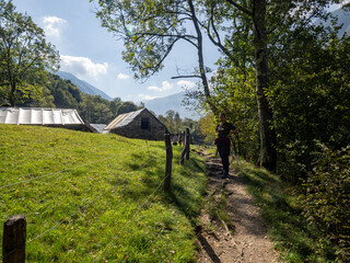 Hiker resting on Verzasca River trail (Sentiero Verzasca) from Sonogno to Lavertezzo, Switzerland © Catalin