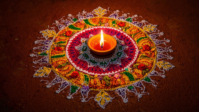 Diwali festival clay lamp centered on traditional colorful sand rangoli art pattern with festival cultural hinduism celebration tradition colorful religious spiritual ceremony abstract