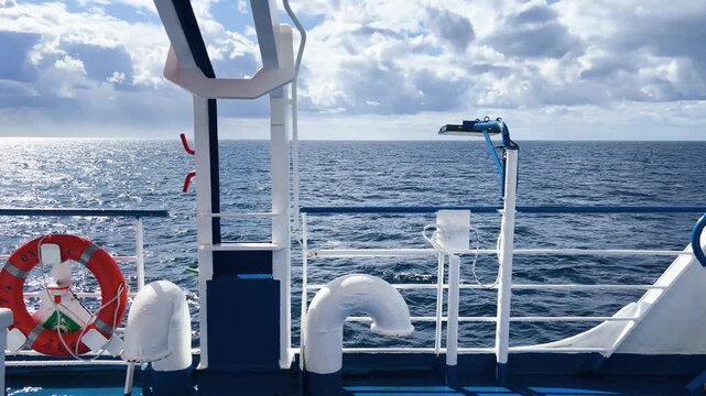 Ship deck railing with lifebuoy and open sea