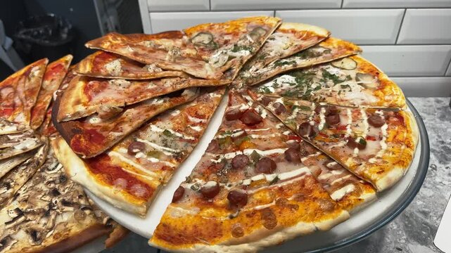 Pizza slices with sausage, mushrooms, cheese and herbs stacked on a round platter indoors, Italian cuisine, savory meal, assorted toppings