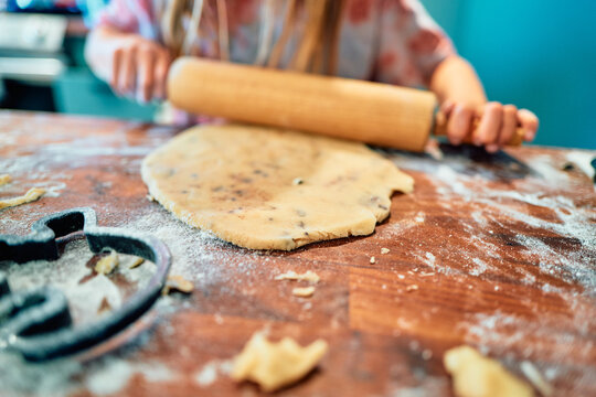 Rolling Out Chocolate Chip Cookie Dough with Cookie Cutters Nearby