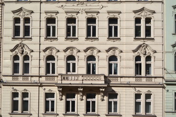 Neo baroque building facade with central balcony and decorative arched windows in prague for architectural background and exterior design © iri.madrid.art