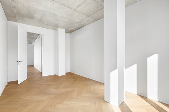 Modern empty apartment room interior mockup with white walls, column, and open door.