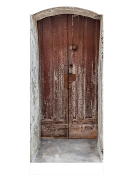 Ancient rustic brown wooden entrance door with peeling paint and weathered texture, set in an old stone arch wall. Isolated