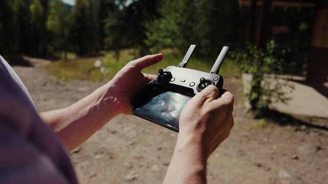 Hands operating drone remote controller close up